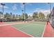 Outdoor tennis court with green playing surface and red perimeter at 27227 Roanoke Dr, Leesburg, FL 34748