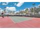 Outdoor tennis court with lighting and perimeter fencing at 27227 Roanoke Dr, Leesburg, FL 34748