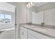 Contemporary bathroom featuring dual vanity sinks and bright lighting, adjacent to a well-lit bedroom at 3106 Voyager Ave, Saint Cloud, FL 34771