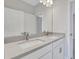 Modern bathroom featuring dual sinks, white cabinetry, and sleek faucets, providing comfort and functionality at 3106 Voyager Ave, St Cloud, FL 34771