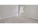 Bright bedroom with gray carpet, gray walls, white trim and a window at 3106 Voyager Ave, St Cloud, FL 34771
