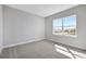 Bright bedroom featuring soft carpet, a large window, and ample natural light, creating a cozy atmosphere at 3106 Voyager Ave, St Cloud, FL 34771