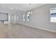 Spacious living room with hardwood floors, white walls, and natural light at 3106 Voyager Ave, St Cloud, FL 34771