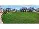 Expansive community green space with lush grass and well-maintained landscaping in a residential area at 6521 Daypack Ln, St Cloud, FL 34771