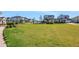 Expansive green community lawn area with manicured landscaping, offering a serene outdoor space at 6521 Daypack Ln, St Cloud, FL 34771