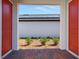 View from the entryway showcasing a glimpse of the community green and the neighboring properties at 6521 Daypack Ln, St Cloud, FL 34771