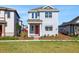Inviting two-story home featuring a red front door, professional landscaping, and a lush lawn at 6521 Daypack Ln, St Cloud, FL 34771