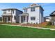 Two-story home with light blue siding, red front door, and a lush green lawn in a residential neighborhood at 6521 Daypack Ln, St Cloud, FL 34771
