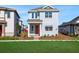 Charming two-story home featuring a red front door, light blue siding, and a well-manicured lawn at 6521 Daypack Ln, St Cloud, FL 34771