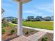 View from the porch to the neighboring houses, manicured lawn, and a blue sky at 6521 Daypack Ln, St Cloud, FL 34771