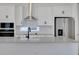 Bright kitchen features stainless steel appliances, white cabinetry, and a large island at 6521 Daypack Ln, St Cloud, FL 34771
