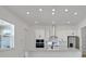 Open kitchen showcases white cabinets, a stainless steel range hood, and recessed lighting at 6521 Daypack Ln, St Cloud, FL 34771