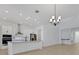 Eat-in kitchen features stainless appliances, an island, and chandelier lighting at 6521 Daypack Ln, St Cloud, FL 34771
