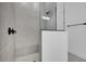 Modern walk-in shower with gray subway tiles and black fixtures at 6521 Daypack Ln, St Cloud, FL 34771