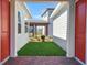View from the entryway revealing a glimpse of the community, landscaping, and other charming houses at 6521 Daypack Ln, St Cloud, FL 34771