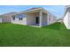 A spacious backyard features a covered patio, perfect for outdoor entertaining at 191 Bottle Brush Dr, Haines City, FL 33844