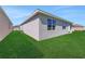 Exterior showing the home's architecture and backyard with lush green grass at 191 Bottle Brush Dr, Haines City, FL 33844