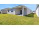 Exterior view of the home showcasing a covered backyard patio at 191 Bottle Brush Dr, Haines City, FL 33844