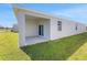 Exterior view of the home showcasing a covered backyard patio at 191 Bottle Brush Dr, Haines City, FL 33844