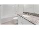 Bathroom featuring granite vanity, tub, shower and tile flooring at 191 Bottle Brush Dr, Haines City, FL 33844