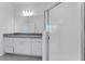 Bathroom featuring vanity with granite countertops, framed shower, and ample space at 191 Bottle Brush Dr, Haines City, FL 33844