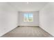 Bright bedroom with a large window offering plenty of natural light and neutral carpeting at 191 Bottle Brush Dr, Haines City, FL 33844
