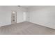This spacious bedroom features neutral carpet, white walls, and an en suite bathroom at 191 Bottle Brush Dr, Haines City, FL 33844
