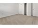 Clean bedroom featuring neutral carpet and a closet and door for storage at 191 Bottle Brush Dr, Haines City, FL 33844
