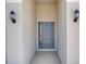 Inviting entryway with a stylish front door and decorative lighting fixtures at 191 Bottle Brush Dr, Haines City, FL 33844