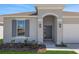 Close-up of the home's front entrance shows an arched entryway and sleek gray door at 191 Bottle Brush Dr, Haines City, FL 33844