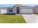 Charming single-story home with a well-manicured lawn and an attached two-car garage at 191 Bottle Brush Dr, Haines City, FL 33844