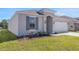Charming single-story home featuring a well-maintained lawn and a grey color scheme at 191 Bottle Brush Dr, Haines City, FL 33844