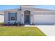 Charming single-story home with a well-manicured lawn and an attached two-car garage at 191 Bottle Brush Dr, Haines City, FL 33844