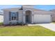 Charming single-story home with a well-manicured lawn and an attached two-car garage at 191 Bottle Brush Dr, Haines City, FL 33844