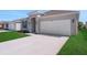 Charming single-story home features a well-manicured lawn and attached two-car garage at 191 Bottle Brush Dr, Haines City, FL 33844