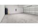 Spacious two-car garage with concrete flooring and a white brick wall at 191 Bottle Brush Dr, Haines City, FL 33844