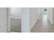 Hallway shows gray floor tiles and a view into a carpeted room at 191 Bottle Brush Dr, Haines City, FL 33844