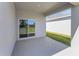 Covered outdoor patio area featuring a sliding glass door to the home interior at 191 Bottle Brush Dr, Haines City, FL 33844