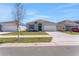 A well-maintained house with a two-car garage and a manicured front lawn on a quiet street at 191 Bottle Brush Dr, Haines City, FL 33844