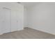 Bright bedroom featuring neutral carpet, white walls, closet, and access to another room at 207 Bottle Brush Dr, Haines City, FL 33844