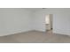 Bright bedroom featuring neutral carpet, white walls, closet, and access to a bath at 207 Bottle Brush Dr, Haines City, FL 33844