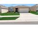 Charming single-story home with a well-manicured lawn and attached two-car garage at 207 Bottle Brush Dr, Haines City, FL 33844