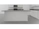 Bright kitchen featuring white cabinets, granite countertops, and stainless steel appliances at 207 Bottle Brush Dr, Haines City, FL 33844
