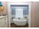 Bathroom with a large, white, freestanding tub at 2360 Park Forest Blvd, Mount Dora, FL 32757