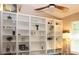 Built-in white shelves filled with decorative items and books at 2360 Park Forest Blvd, Mount Dora, FL 32757