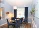 Charming dining room featuring a round glass table and four blue chairs at 2360 Park Forest Blvd, Mount Dora, FL 32757