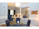 Bright dining room with glass table and four blue velvet chairs at 2360 Park Forest Blvd, Mount Dora, FL 32757