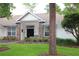 Brick front home with a welcoming porch and mature trees at 2360 Park Forest Blvd, Mount Dora, FL 32757