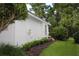 The exterior showcases well-maintained landscaping and manicured hedges along the side of the property at 2360 Park Forest Blvd, Mount Dora, FL 32757
