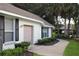 Home's side exterior showcasing a garage door, window shutters, and manicured landscaping at 2360 Park Forest Blvd, Mount Dora, FL 32757